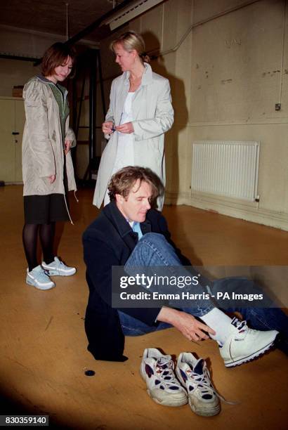 Robert Bathhurst who stars in the ITV drama Cold Feet, laces up his trainers, whilst Helen Baxendale and Hermione Norris look on, in central London,...