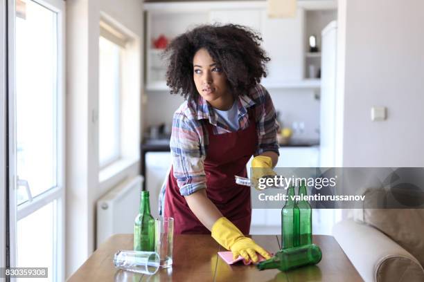 young woman cleaning kitchen - cleaning after party stock pictures, royalty-free photos & images