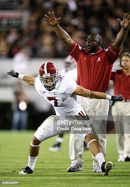 Assitant running back coach Sedrick Irvin and Will Oakley of the Alabama Crimson Tide celebrate after the Crimson Tide scored a touchdown in the...