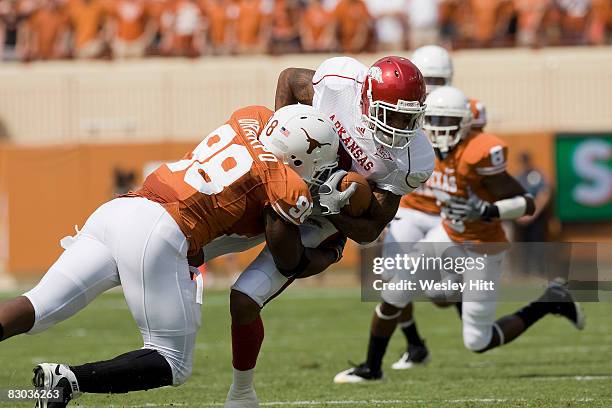 Brian Orakpo of the Texas Longhorns tackles London Crawford of the Arkansas Razorbacks at Darrell K. Royal-Texas Memorial Stadium on September 27,...