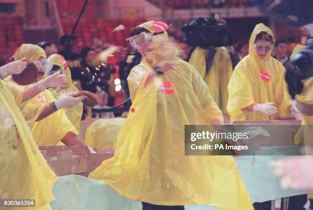 Competitors having a fling whilst taking part in the world's biggest custard pie fight held at The Millennium Dome, in south London.