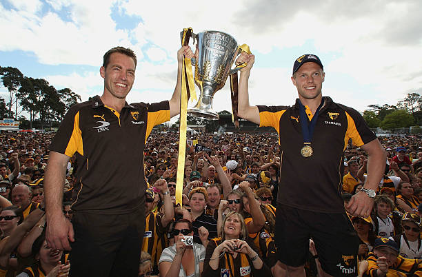 Alastair Clarkson coach of the Hawks and Sam Mitchell the captain hold up the 2008 AFL Premiership Cup during the Hawthorn Hawks AFL Grand Final...