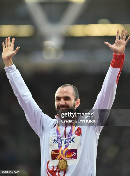 Gold medallist Turkey's Ramil Guliyev poses on the podium during the victory ceremony for the men's 200m athletics event at the 2017 IAAF World...