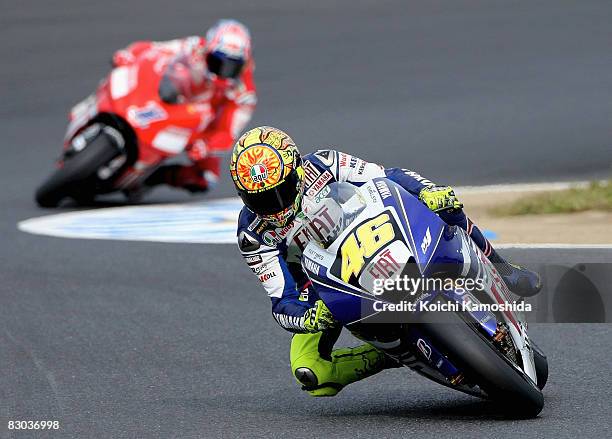 Valentino Rossi of Italy and the Fiat Yamaha Team leads Casey Stoner of Australia and the Ducati Marlboro Team during the MotoGP World Championship...