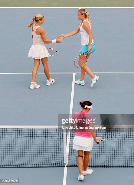 Vera Dushevina of Russia returns and Maria Kirilenko of Russia react after winning a point against Chia-Jung Chuang and Se-Wei Hsieh of Chinese...
