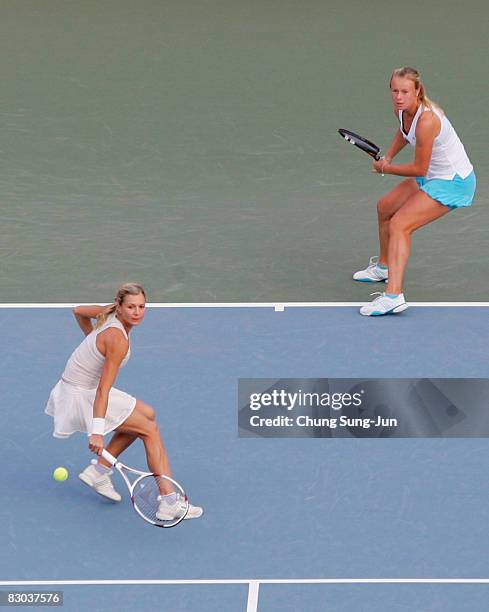 Maria Kirilenko of Russia returns a shot as doubles partner Vera Dushevina of Russia looks on during their doubles final match against Chia-Jung...