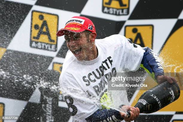 Valentino Rossi of Italy and the Fiat Yamaha Team celebrates his victory during an award ceremony of the MotoGP World Championship Grand Prix of...