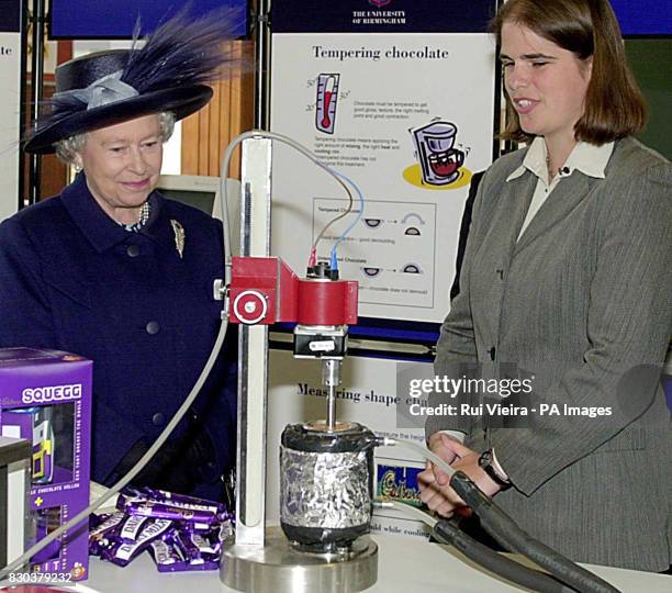 Queen Elizabeth II talks to student Kerstin Pinschower about chocolate tempering during a visit at the School of Chemical Engineering at the...