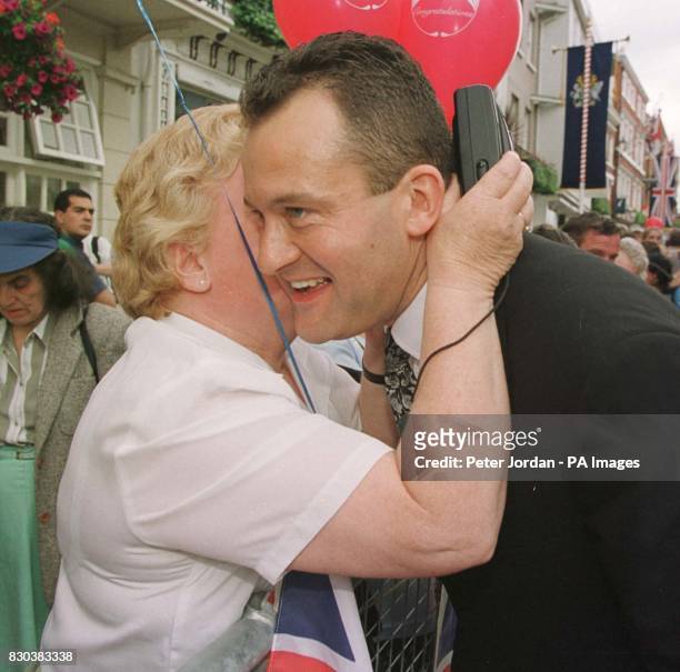 Princess Diana's former butler Paul Burrell receives a kiss from 60 year-old Margaret Morrison from Glenrothes, Scotland, before the wedding of HRH...