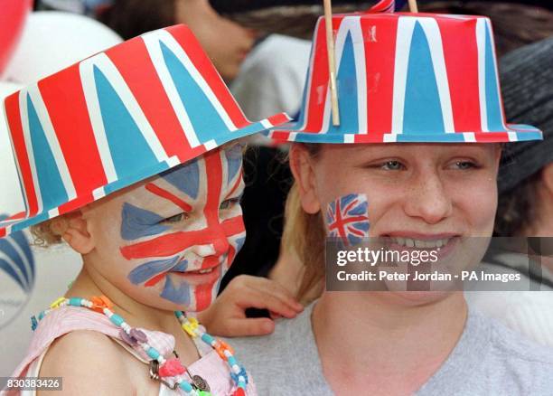 Amy, aged 3, and her mother Louise Shepard with Union Jack flags painted on their faces, wait among the crowd at Windsor before the royal wedding...