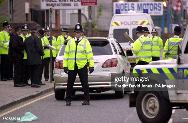 West Midlands Police mount a roadblock in the Handsworth area of Birmingham to gather information about recent shootings in the city.