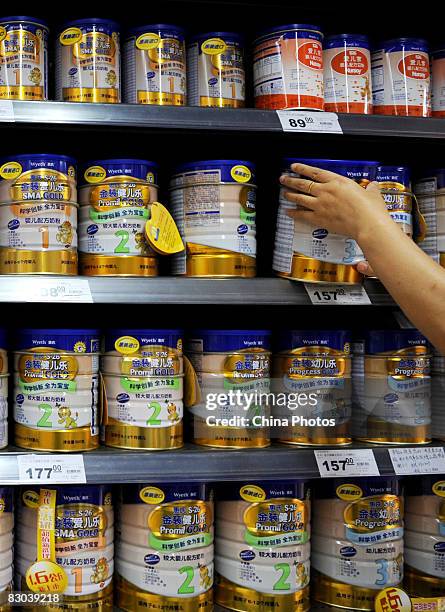 Woman shops for powdered milk at a supermarket on September 28, 2008 in Chengdu of Sichuan Province, China. Approximately 53,000 infants were...