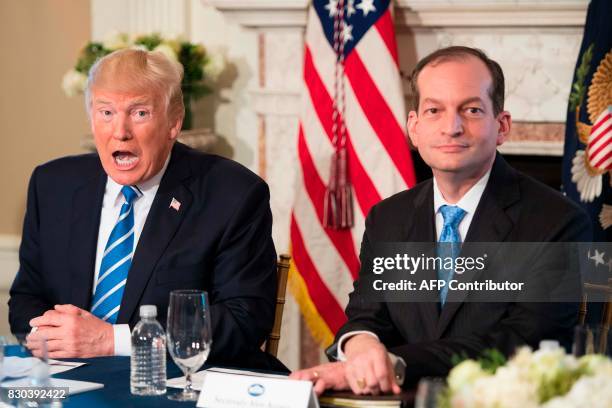 President Donald Trump speaks to the press with US Labor Secretary Alexander Acosta on August 11 at his Bedminster National Golf Club in New Jersey....