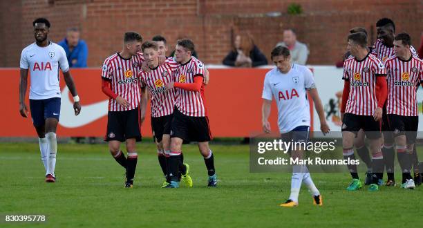 Denver Hume of Sunderland is congratulated by his team mates after scoring the winning goal during the Premier League 2 match between Sunderland and...