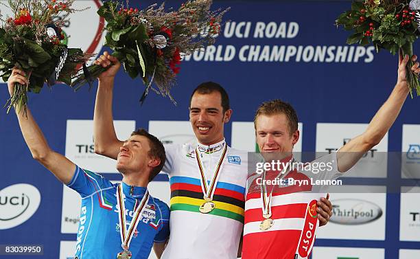 Damiano Cunego of Italy and compatriot Alessandro Ballan and Matti Breschel of Denmark stand on the podium after the Elite Men's Road Race during the...