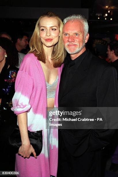 Actors Saffron Burrows and Malcolm McDowell, arrive at the World Charity premiere, in aid of the charity The Peacock Gymnasium, of their film...