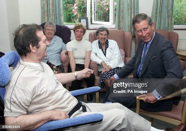 The Prince of Wales talks to Granville Dyson , aged 63, a day patient at the Prince of Wales Hospice, in Pontefract, during his visit to the...