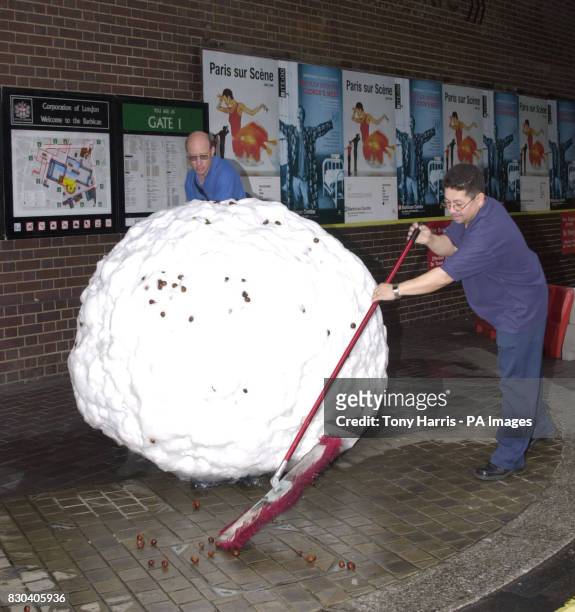 Workmen in London manoeuvre into position a giant snowball which is forming part of an unusual art exhibition in London. The thirteen one ton...