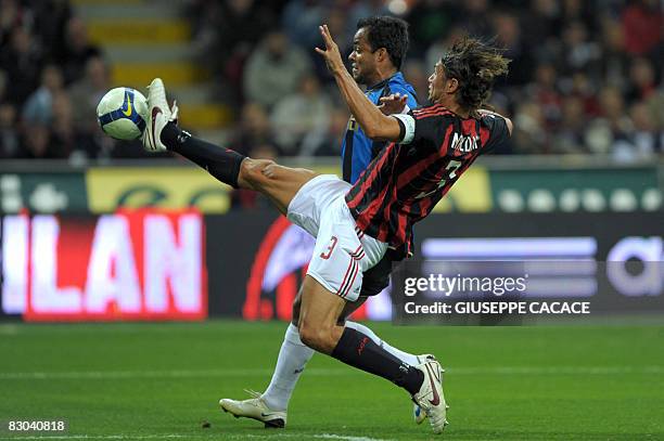 MIlan's defender Paolo Maldini vies with Inter Milan's Brazilian midfielder Amantino Alessandro Mancinil during their "Serie A" football match at San...