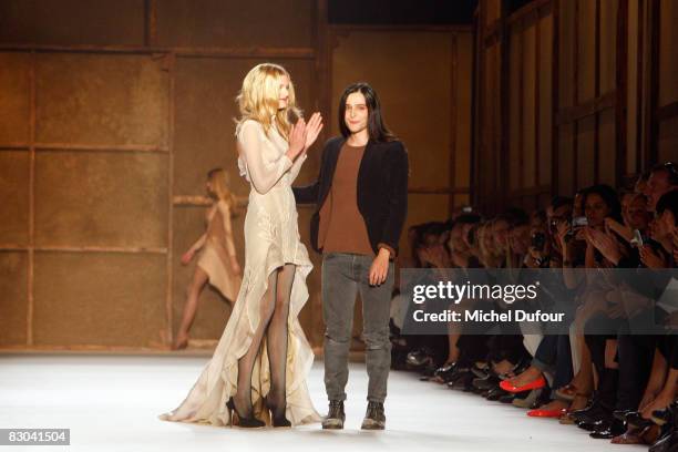 Designer Olivier Theyskens and a model walk down the catwalk during the Nina Ricci PFW Spring Summer 2009 show at Paris Fashion Week 2008 at Espace...