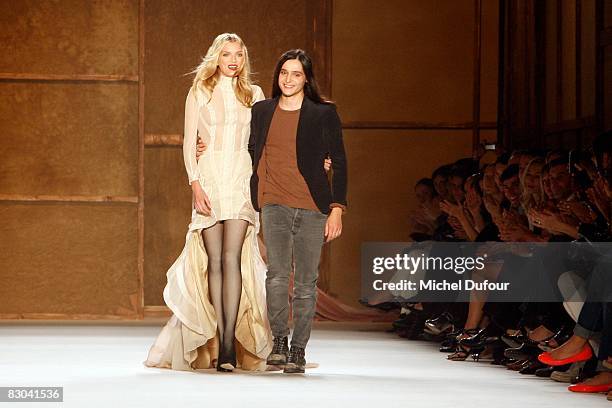 Designer Olivier Theyskens and a model walk down the catwalk during the Nina Ricci PFW Spring Summer 2009 show at Paris Fashion Week 2008 at Espace...