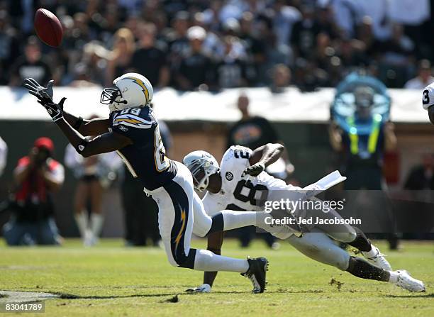 Chris Chambers of the San Diego Chargers catches a pass over Gibril Wilson of the Oakland Raiders during an NFL game on September 28, 2008 at McAfee...