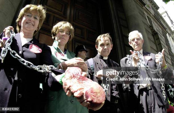 Ann Pettifor, Director of Jubilee 2000, Jenny Allan, Rev Chris Brice and Michael Taylor, President of the Jubilee 2000 coalition, stand chained...