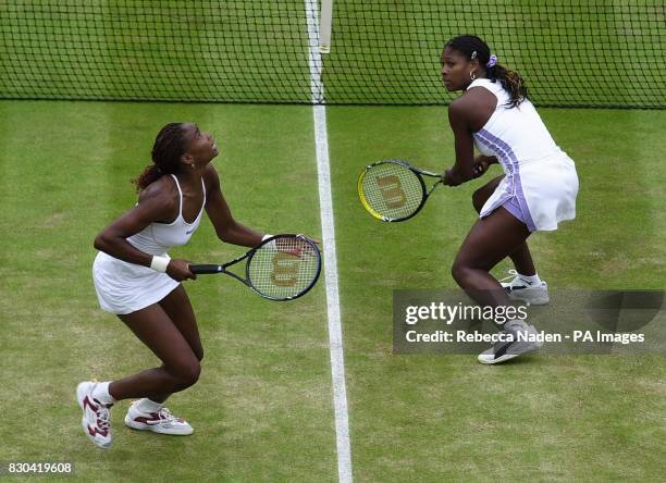 Venus Williams and her sister Serena Williams in action during their doubles match against Anna Kournikova and Natasha Zvereva at Wimbledon.