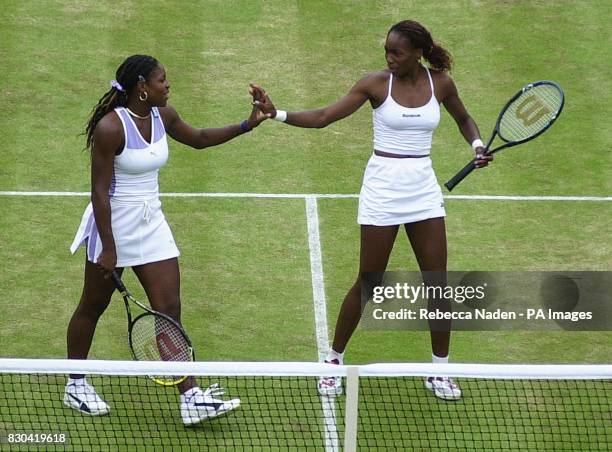 Venus Williams and her sister Serena Williams celebrate during their doubles match against Anna Kournikova and Natasha Zvereva at Wimbledon.