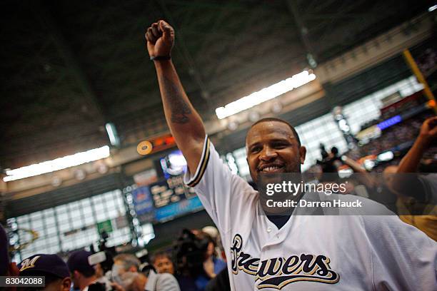 Starting pitcher CC Sabathia of the Milwaukee Brewers pumps his fist after pitching a complete game as they celebrate clinching the National League...
