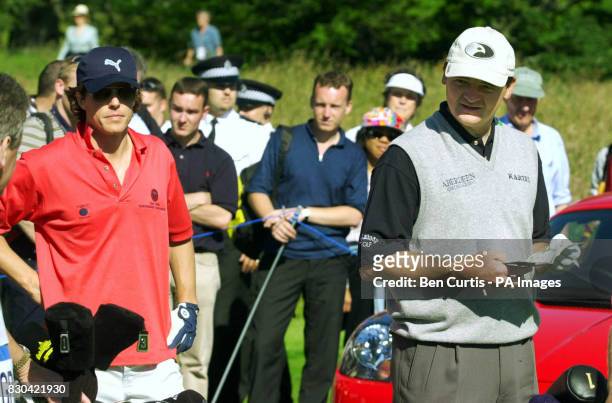 Actor Hugh Grant and 1999 Open winner Paul Lawrie on the course during the Roxburghe Challenge 2000, at the Roxburgh Golf Course near Kelso,...