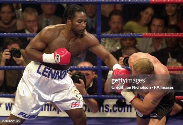 World Heavyweight Champion Lennox Lewis throws a jab at Frans Botha during their WBC and IBF heavyweight title fight at London Arena. Lewis beat...