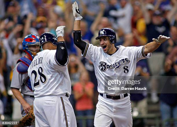 Ryan Braun of the of the Milwaukee Brewers celebrates his game winning two run home run against the Chicago Cubs with teammate Prince Fielder in the...