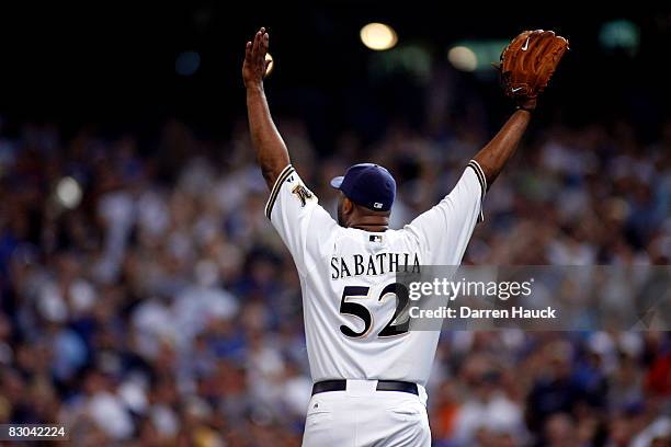 Starting pitcher CC Sabathia of the Milwaukee Brewers celebrates after pitching a complete game against the Chicago Cubs at Miller Park on September...