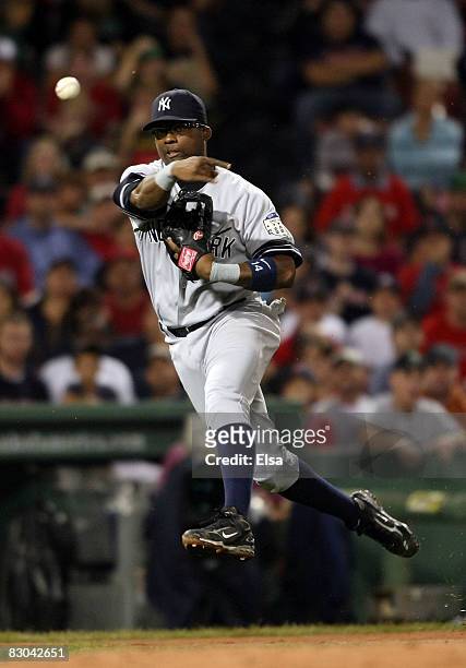 Wilson Betemit of the New York Yankees fields a hit by Gil Velazquez of the Boston Red Sox and sends it to first for the out in the second inning on...