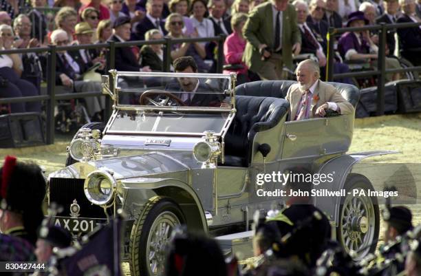 Sir John Mills, being driven in a vintage Rolls Royce Silver Ghost, during the pageant celebrating the Queen Mother's 100th birthday in Horseguards...