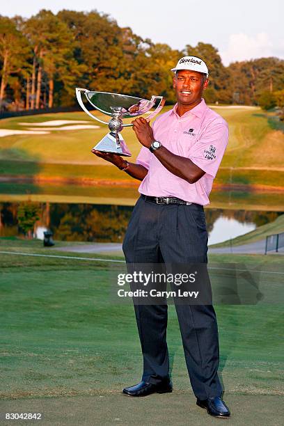 Vijay Singh poses with the FedExCup trophy after the final round of THE TOUR Championship presented by Coca-Cola, at East Lake Golf Club on September...