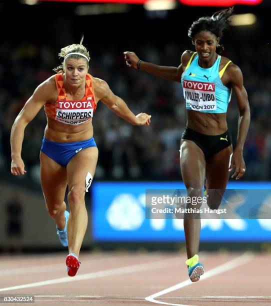 Dafne Schippers of the Netherlands and Shaunae Miller-Uibo of the Bahamas cross the finish line in the Women's 200 metres during day eight of the...