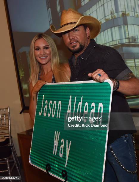 Brittany Kerr and Singer/Songwriter Jason Aldean with signage for "Jason Aldean Way" at The Medical Center, Navicent Health's Eversole Auditorium on...