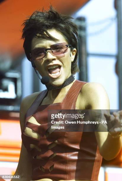 Victoria Beckham, Posh Spice in girl band the Spice Girls, wearing a revealing top whilst performing her song 'Out of your mind', on stage at the...