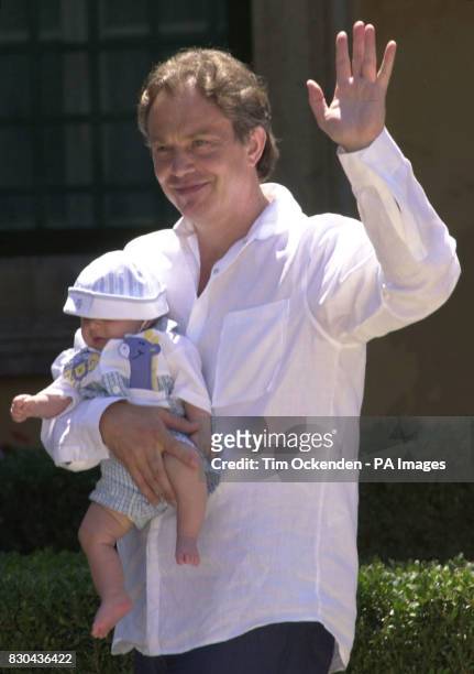 Britain's Prime Minister Tony Blair with baby Leo outside his Tuscan Villa in Italy. Tony Blair and his family posed for a long-awaited holiday...