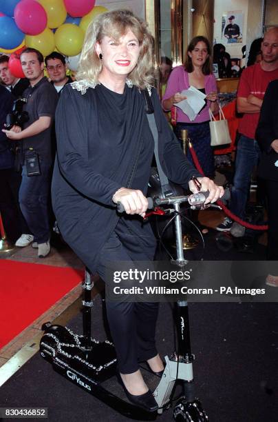 Magician Fay Presto, riding a mini scooter, attending the premiere of the film The Wedding Tackle, at Planet Hollywood in Leicester Square, London.