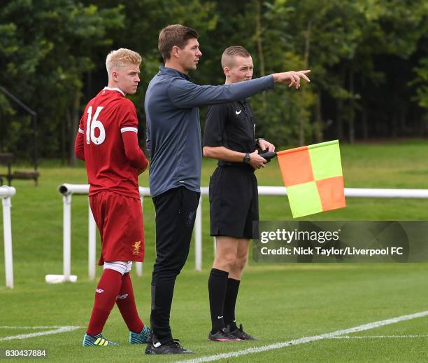 Liverpool U18 manager Steven Gerrard gives instructions to his player while substitute Luis Longstaff waits to join the play during the Derby County...