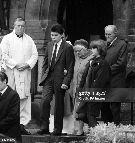 Year old Steven Flannigan is comforted by relatives at the funeral of his sister Joanne who died with their parents in the Pan Am 747 disaster....