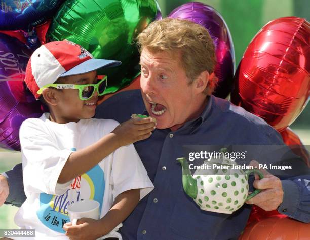 International singer and performer Michael Crawford and four-year-old Joshua Haines, of London, during a tea party after a special performance of...