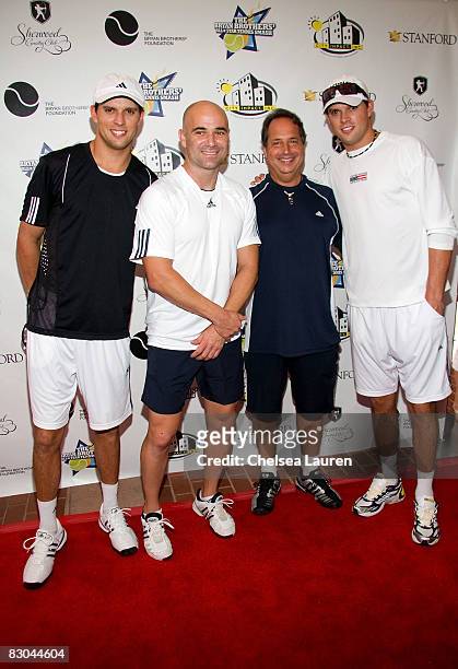 Tennis players Bob Bryan, Andre Agassi, actor Jon Lovitz, and tennis player Mike Bryan arrive at the Bryan Brothers' all-star tennis smash at the...