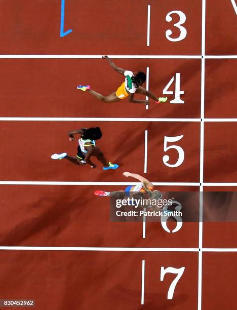 Dafne Schippers of the Netherlands, Shaunae Miller-Uibo of the Bahamas and Marie-Josee Ta Lou of the Ivory Coast cross the finish line in the Women's...