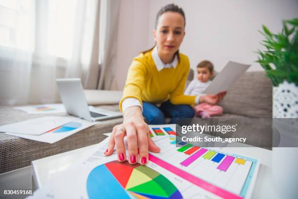 young mother working at home - children looking graph stock pictures, royalty-free photos & images