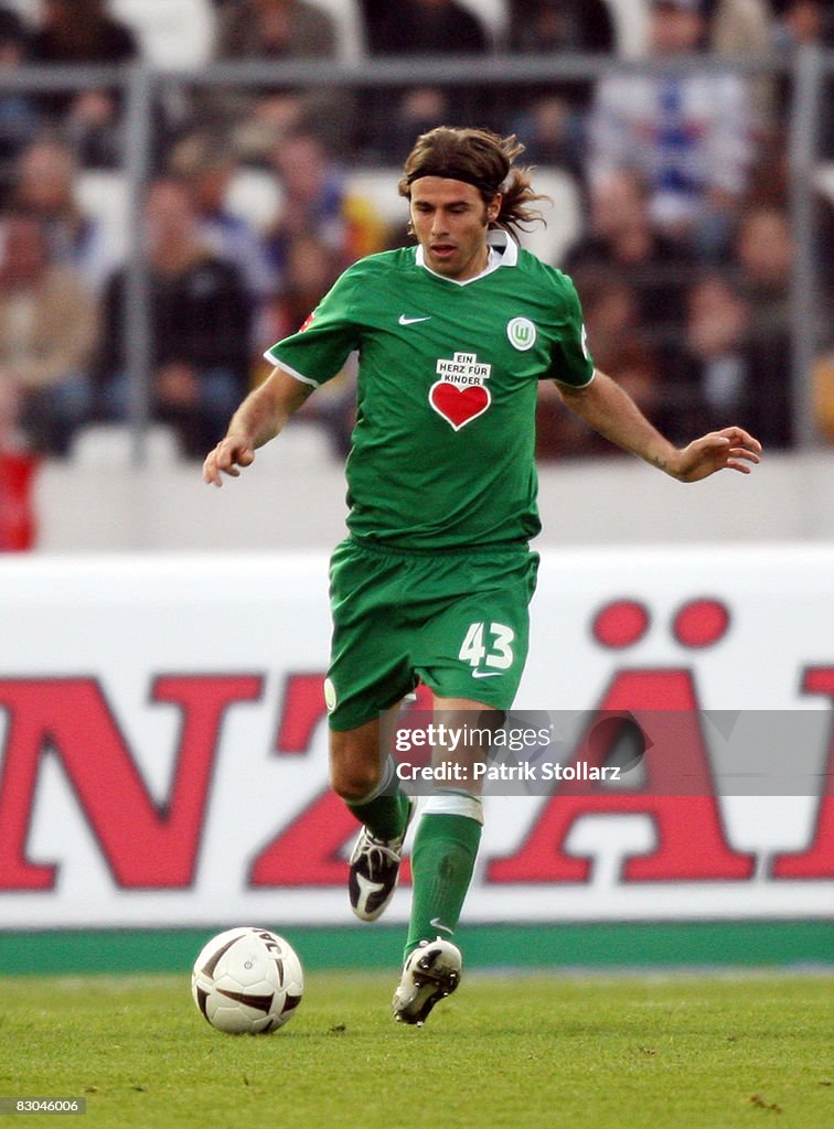 Andrea Barzagli of Wolfsburg runs with the ball during the Bundesliga