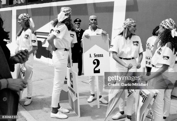 Group of young women hold signs indicating the names and numbers of drivers during the San Marino F1 Grand Prix on the Imola Circuit, Imola, Italy,...